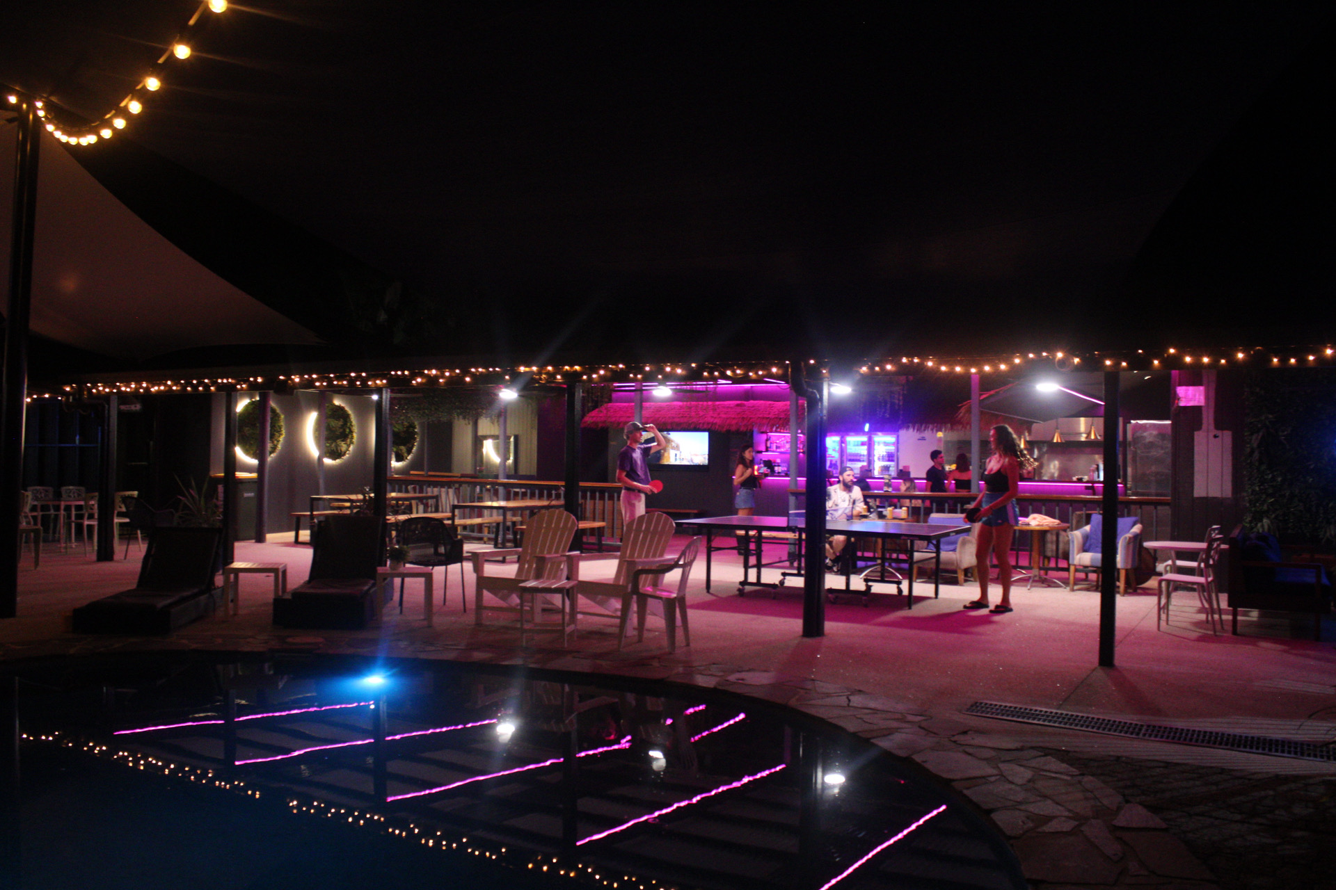 Guests playing ping-pong in the outdoor social courtyard deck